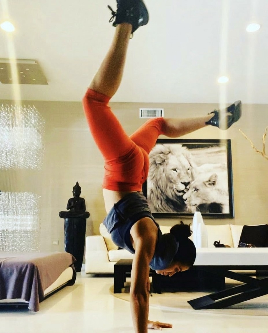 Coach Patty holding a strong handstand showing strength, control and balance